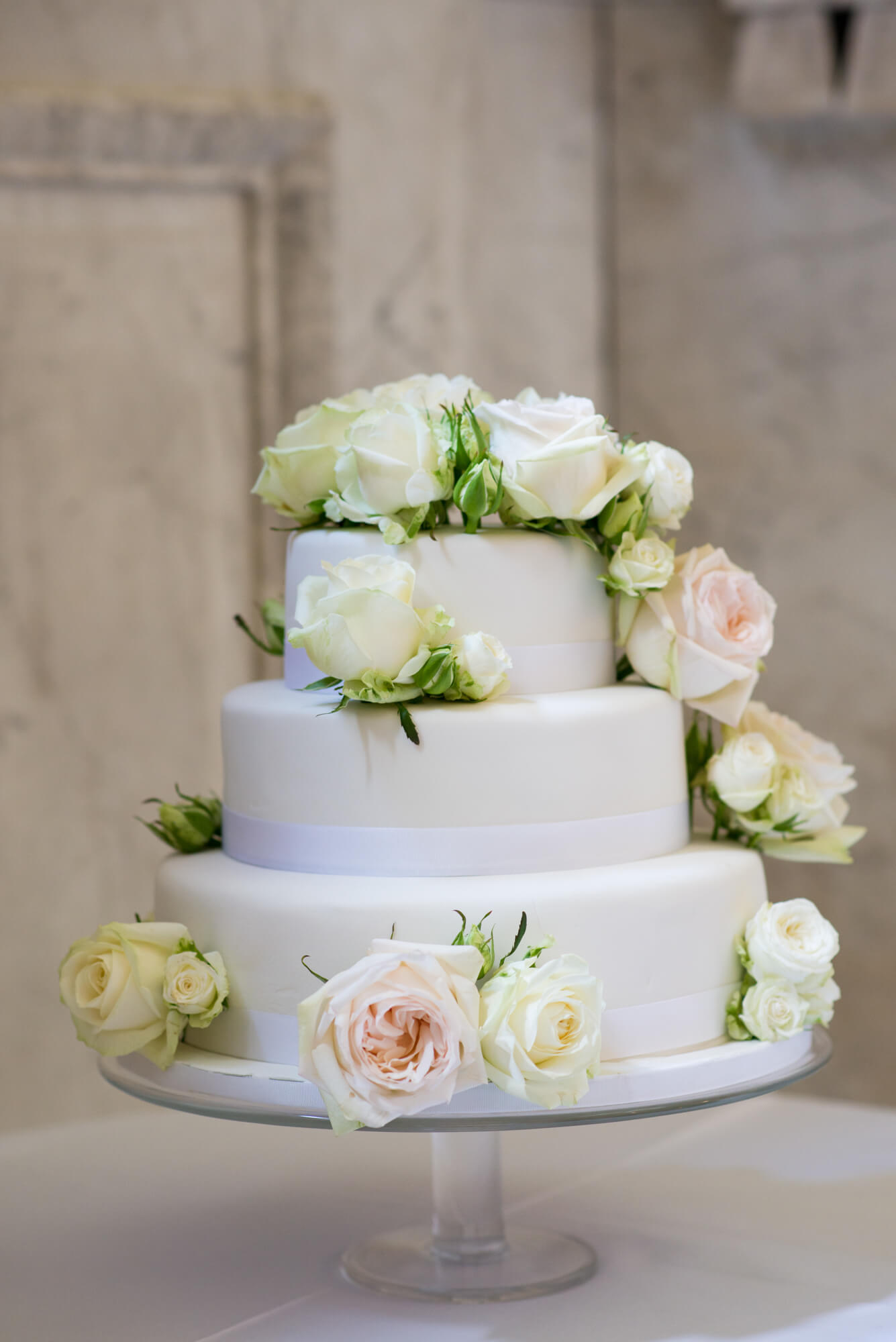 A 3 tiered wedding cake with florals